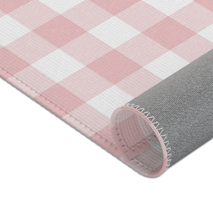Dusty rose gingham area rug in a baby nursery corner
