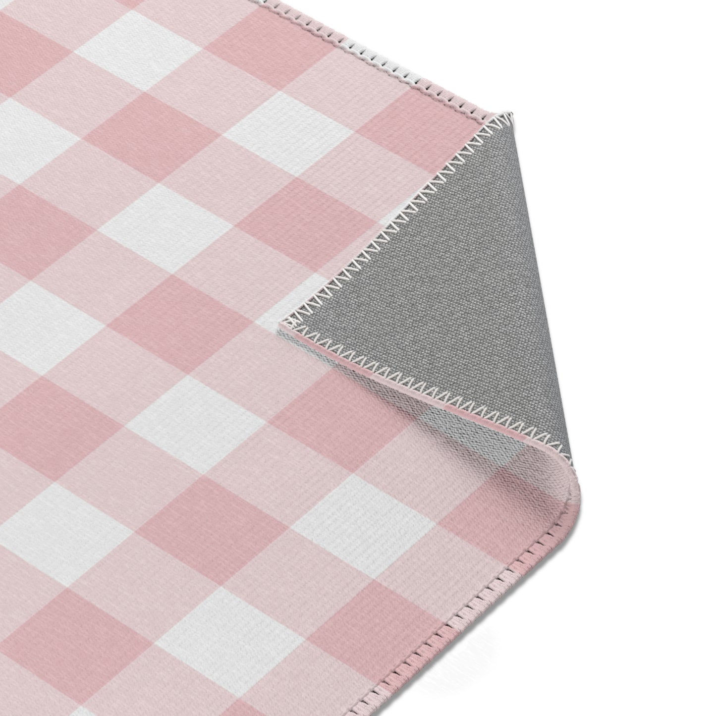 Vintage pink check rug in a small baby room