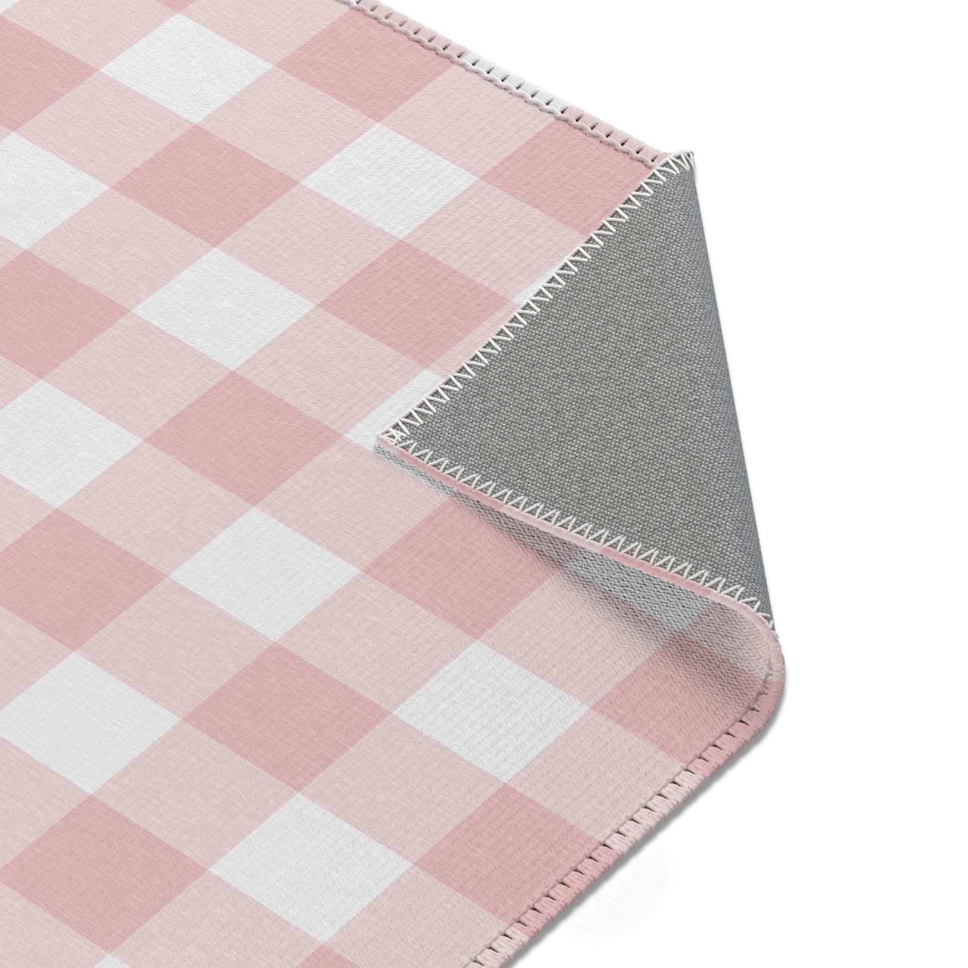 Vintage pink check rug in a small baby room
