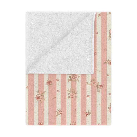Rose Stripe minky baby blanket draped over a crib