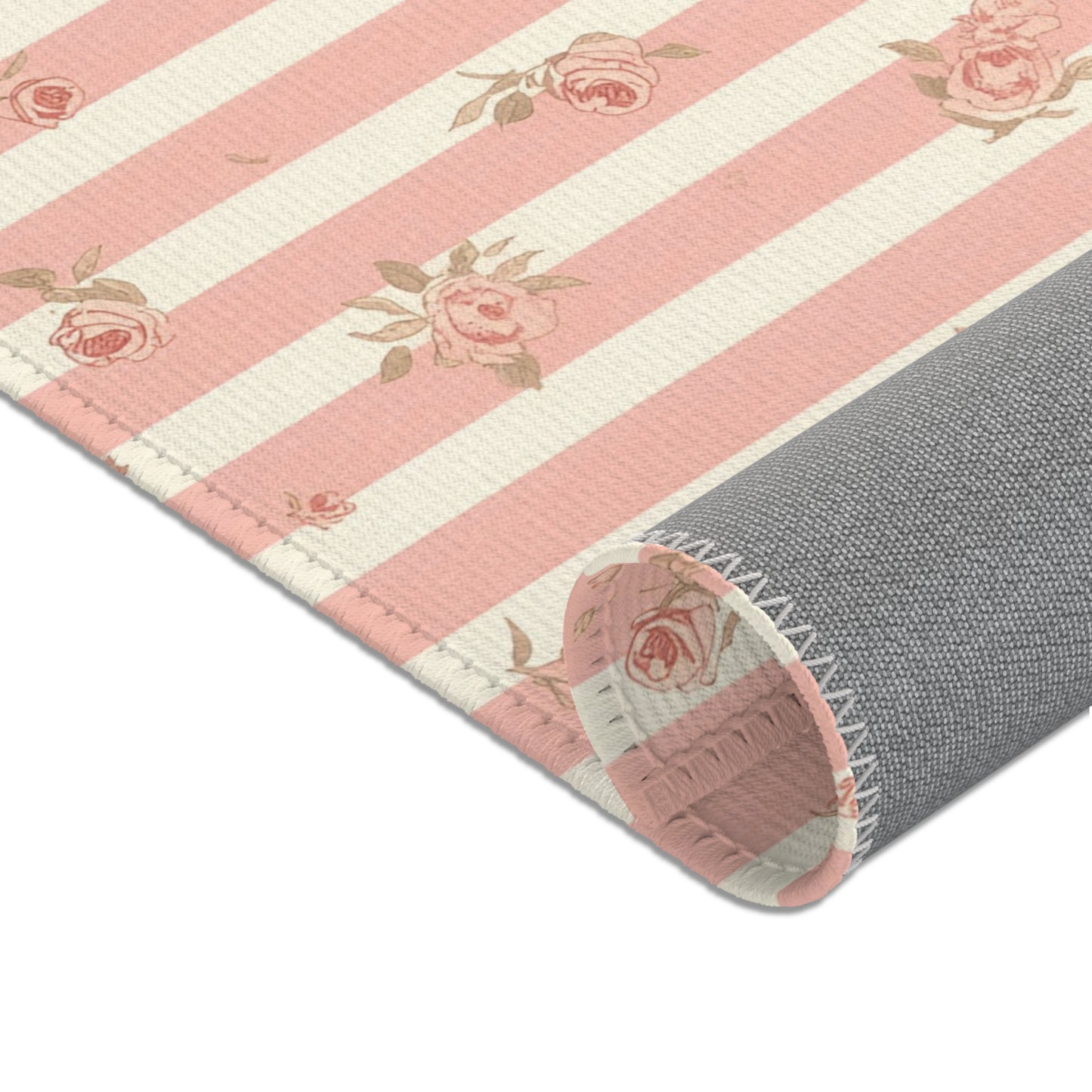 Ticking stripes and scattered roses across the nursery area rug