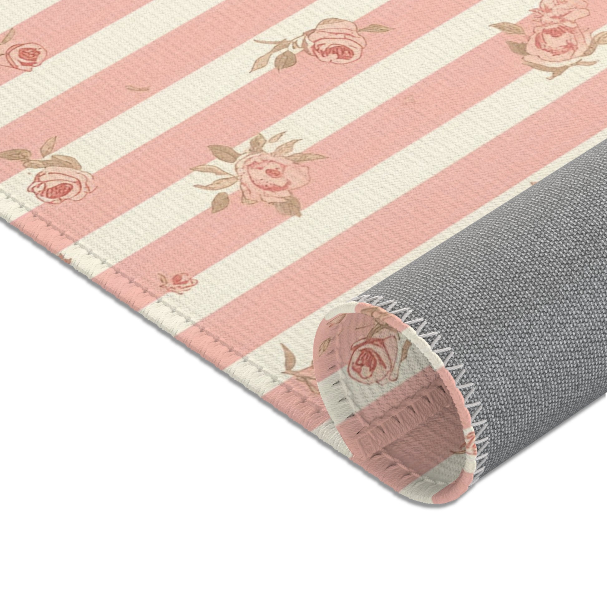 Ticking stripes and scattered roses across the nursery area rug
