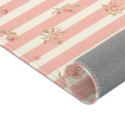 Ticking stripes and scattered roses across the nursery area rug