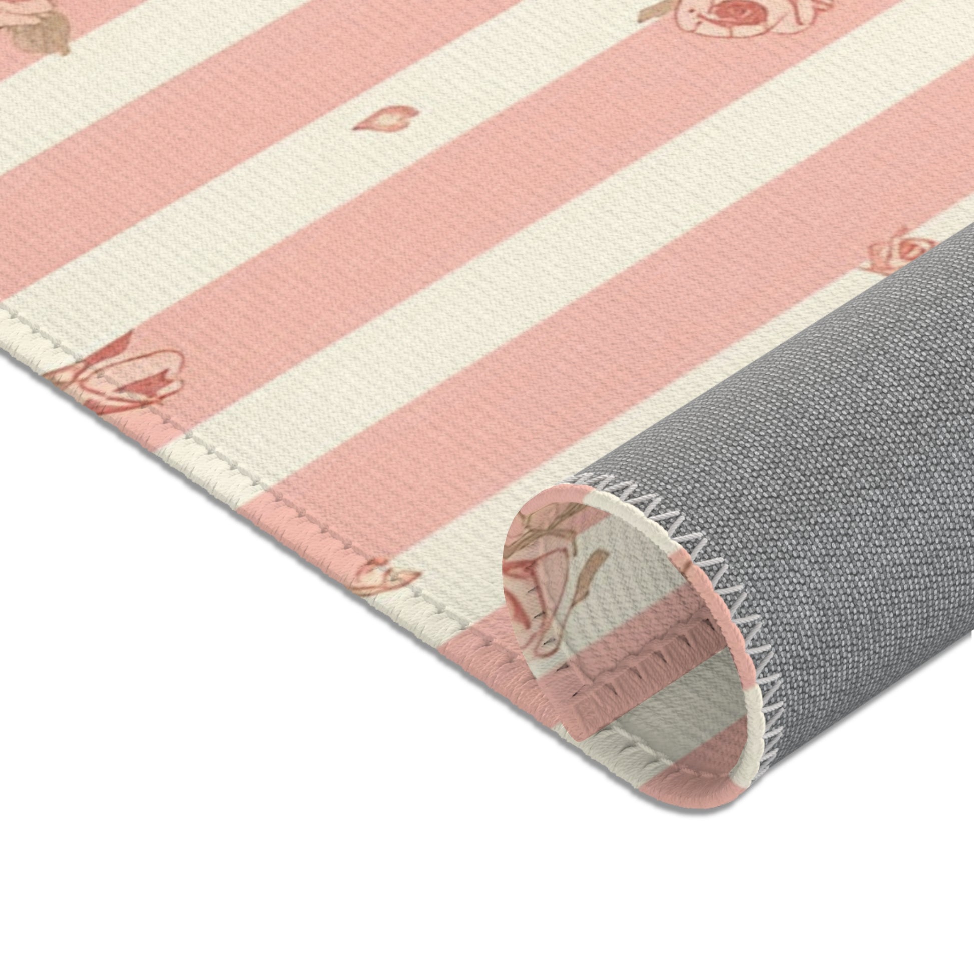 Nursery area rug in a pink, rose and cream palette