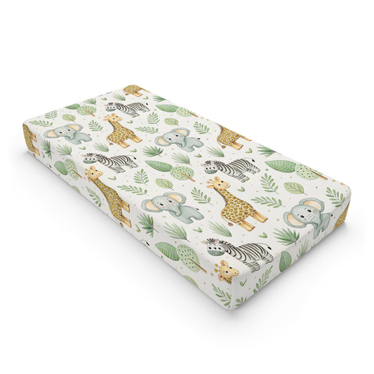 Safari animal changing pad cover on a nursery changing table