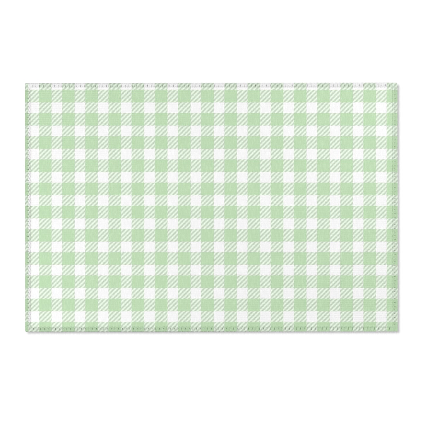 Green gingham area rug beside a nursery crib