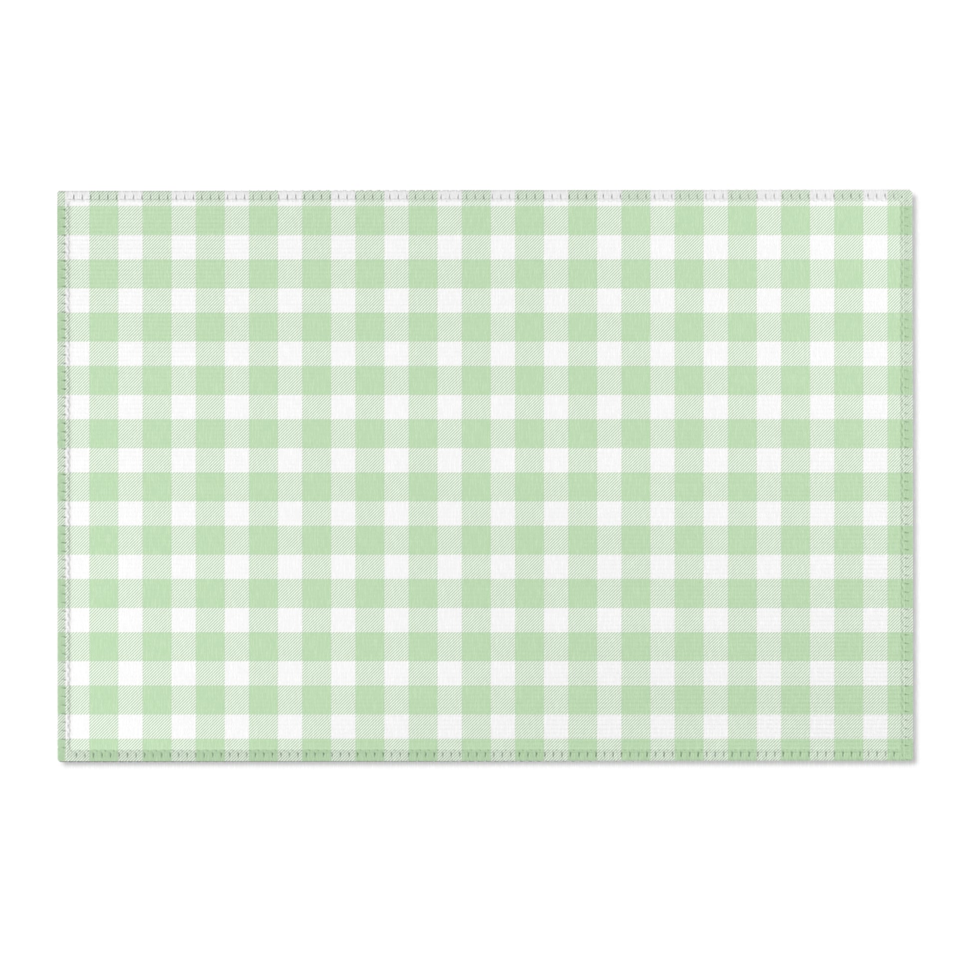 Green gingham area rug beside a nursery crib