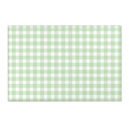 Green gingham area rug beside a nursery crib