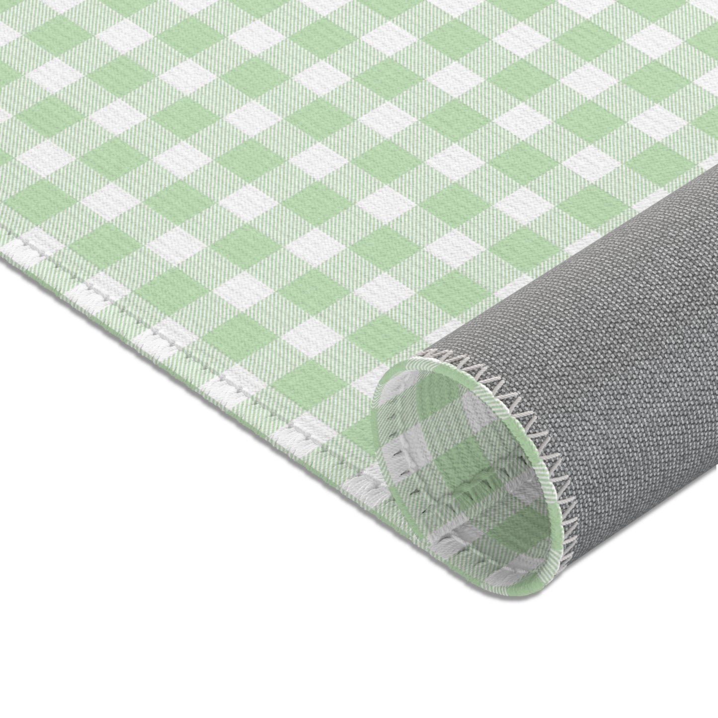 Green gingham nursery rug under a crib