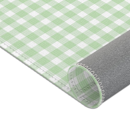 Green gingham nursery rug under a crib