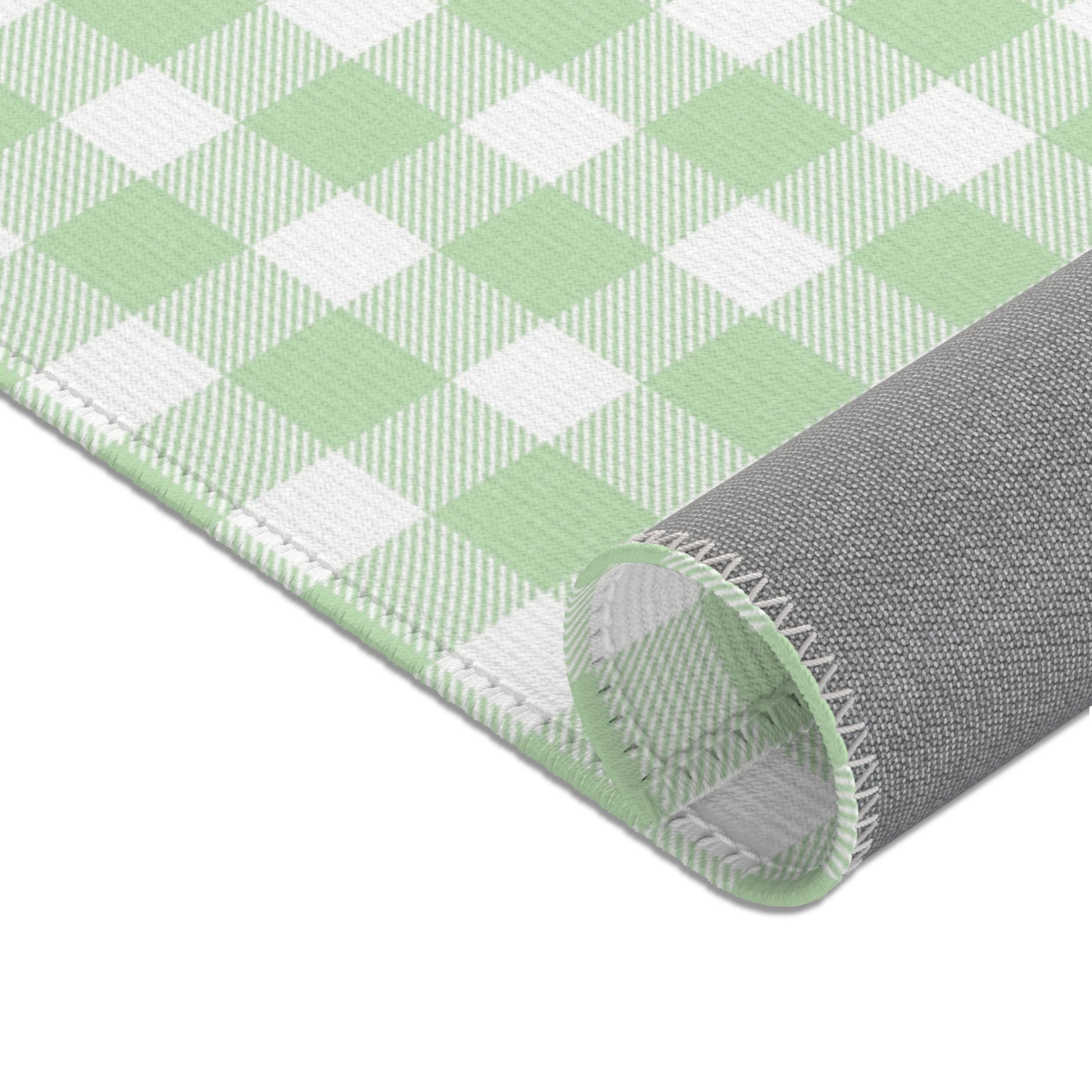 Green gingham area rug in a baby nursery corner