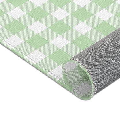 Green gingham area rug in a baby nursery corner