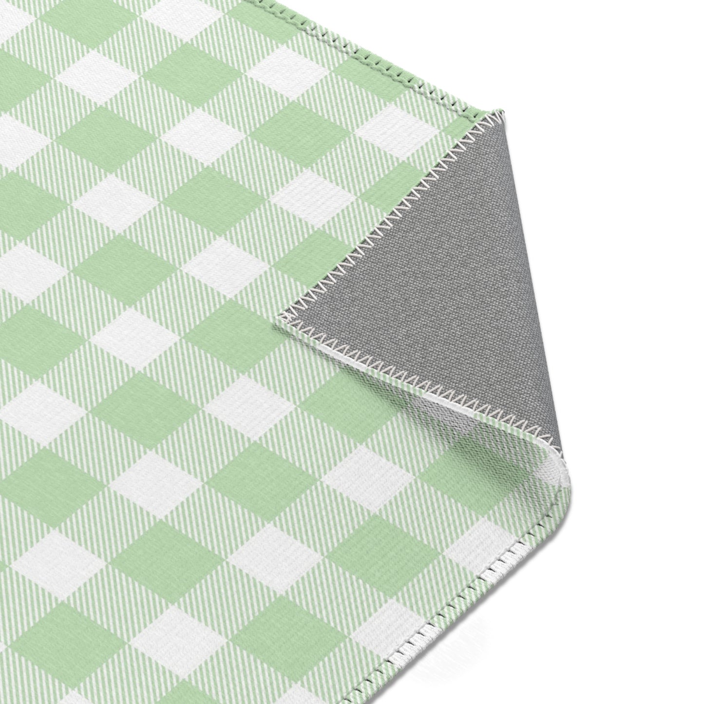 Green and white check rug in a small baby room