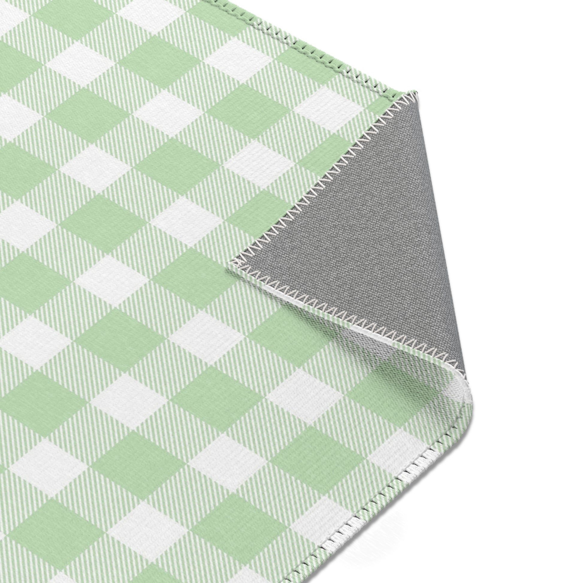 Green and white check rug in a small baby room