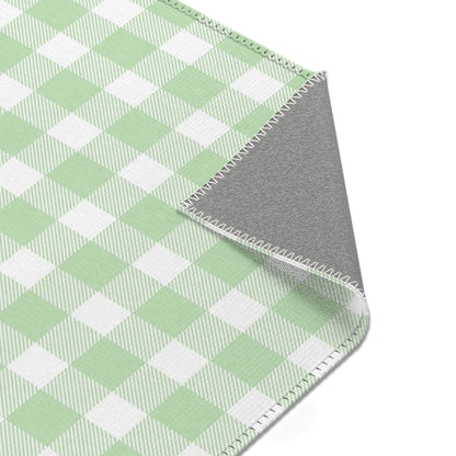 Green and white check rug in a small baby room