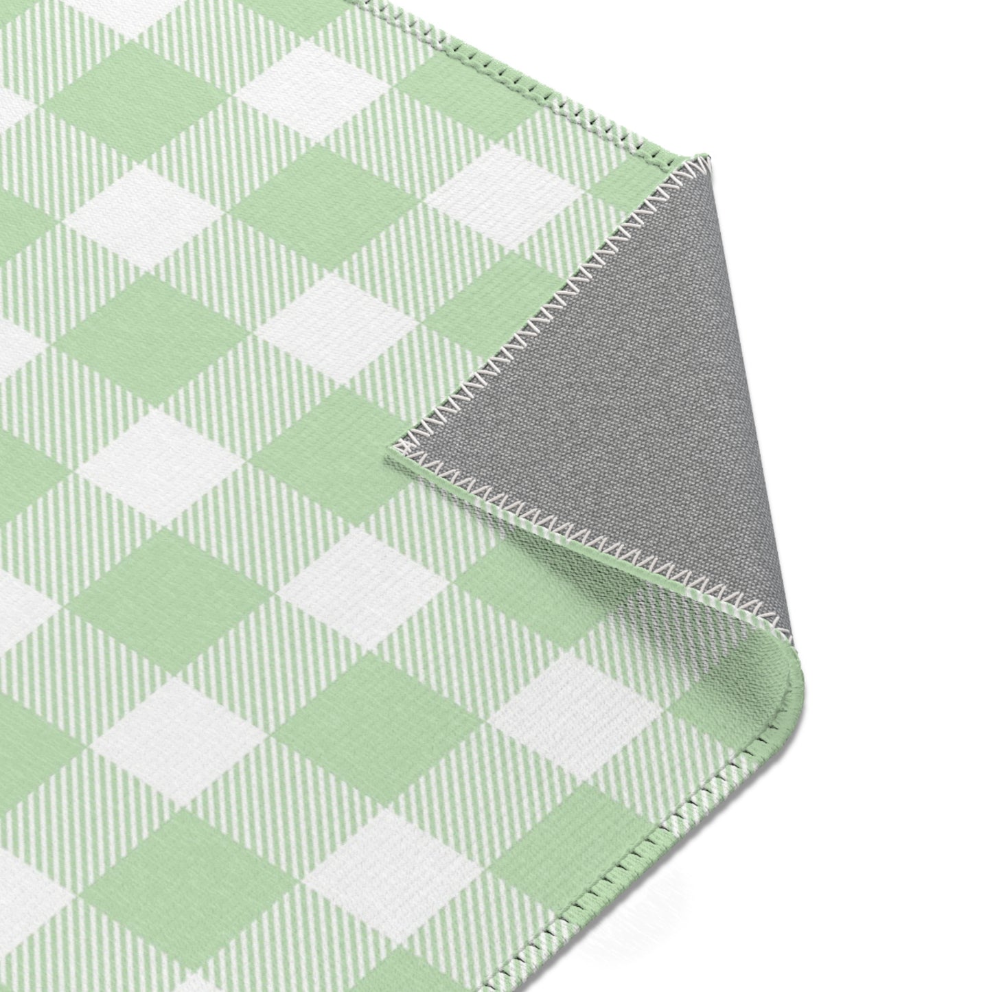 Sage Gingham rug seen from above in a nursery