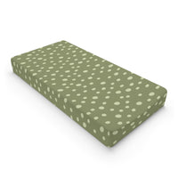 Sage Speckle changing pad cover on a nursery changing table