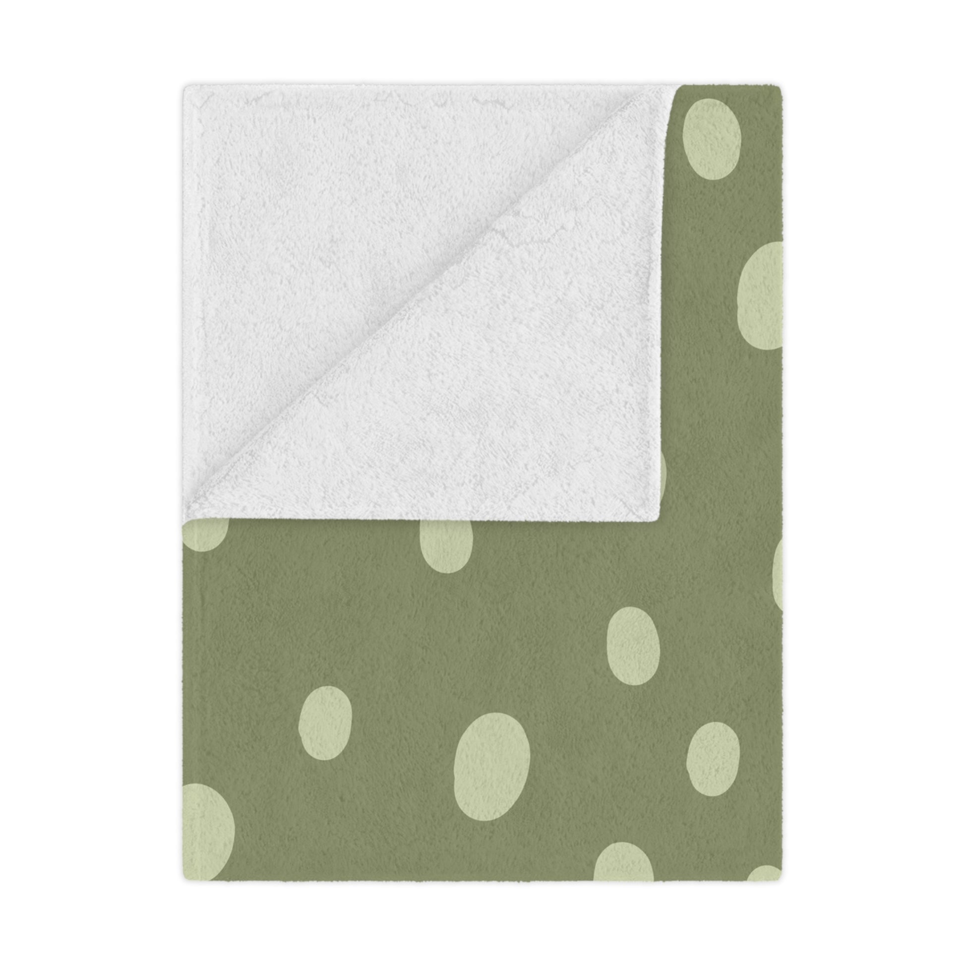 Sage Speckle minky baby blanket draped over a crib