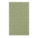 Dotted nursery area rug in cream on soft sage green
