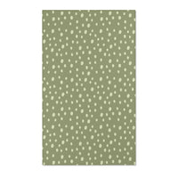 Dotted nursery area rug in cream on soft sage green