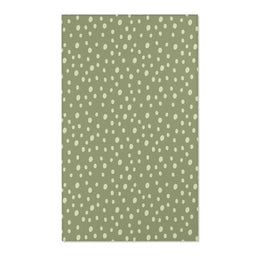 Dotted nursery area rug in cream on soft sage green