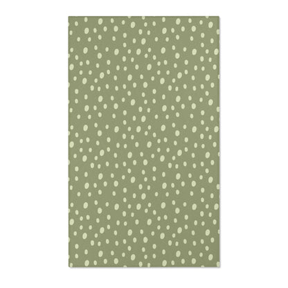 Dotted nursery area rug in cream on soft sage green