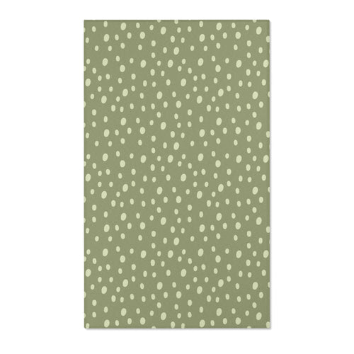 Dotted nursery area rug in cream on soft sage green