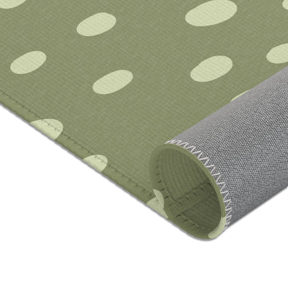 Nursery area rug in a neutral sage green and cream palette