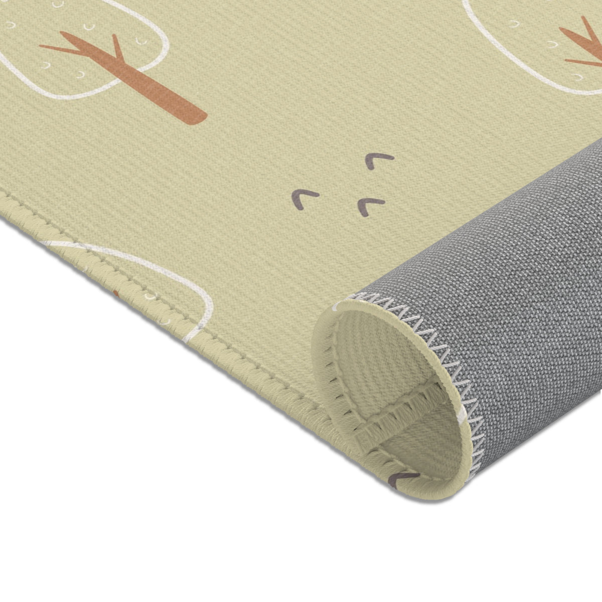 Nursery rug in green and cream in a styled baby room