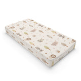 Sleepy safari changing pad cover in warm cream on a nursery changing table