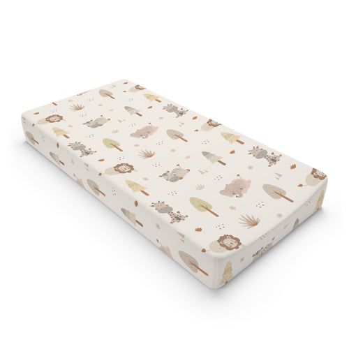 Sleepy safari changing pad cover in warm cream on a nursery changing table