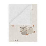 Sleepy safari minky baby blanket draped over a crib