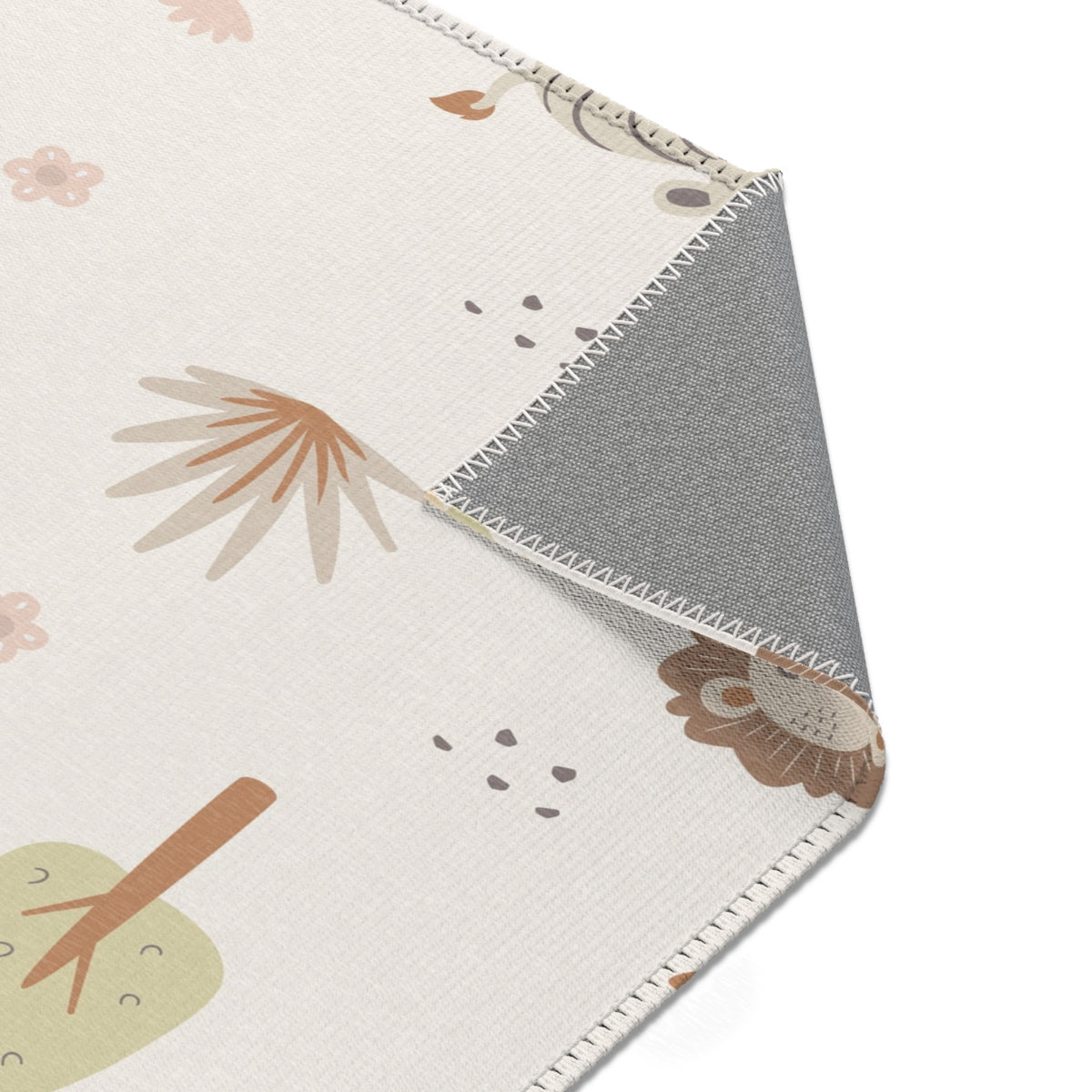 Sleepy safari rug beside a nursery glider chair