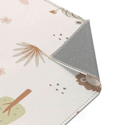 Sleepy safari rug beside a nursery glider chair