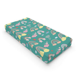 Teal Sky Rainbows changing pad cover on a nursery changing table