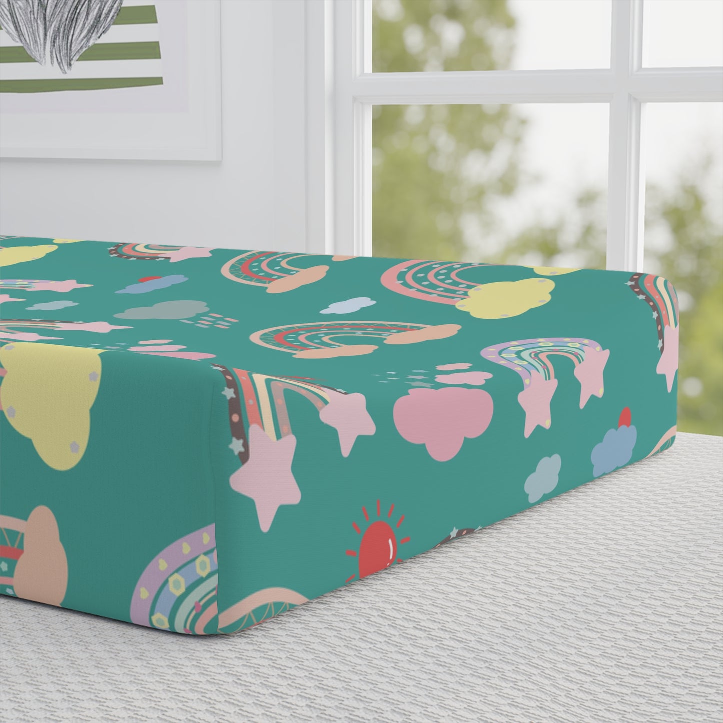 Close detail of the Teal Sky Rainbows print on the changing pad cover