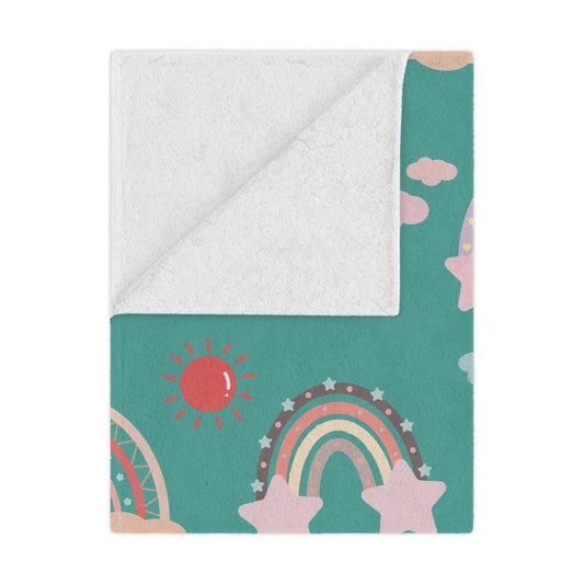 Teal Sky Rainbows minky baby blanket draped over a crib