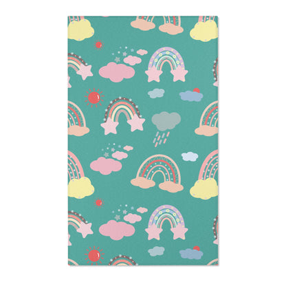 Bright rainbow nursery area rug in coral on deep teal
