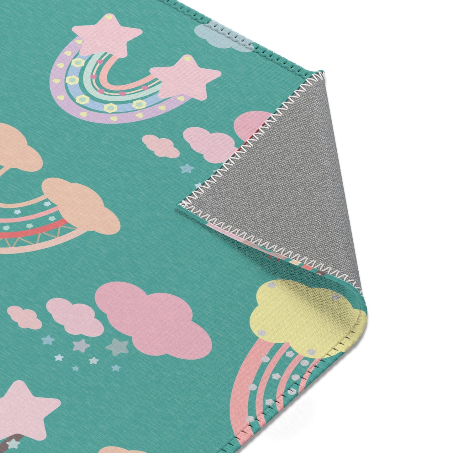 Nursery area rug printed edge to edge with rainbows and clouds
