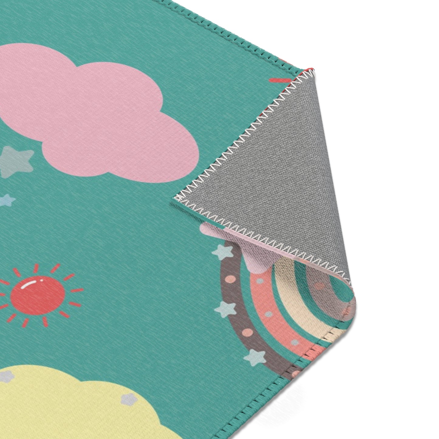 Bright rainbow rug in coral and teal for a nursery floor