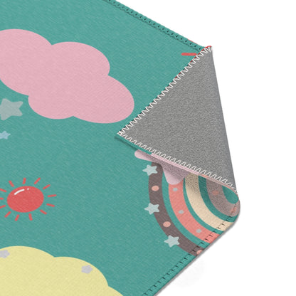 Bright rainbow rug in coral and teal for a nursery floor