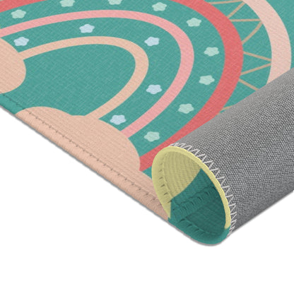 Nursery area rug in a deep teal, coral and pink palette