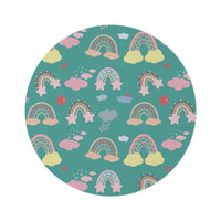 Teal Sky Rainbows round nursery rug on a baby room floor