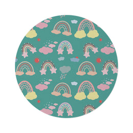 Teal Sky Rainbows round nursery rug on a baby room floor