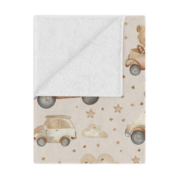 Teddy Roadtrip minky baby blanket draped over a crib