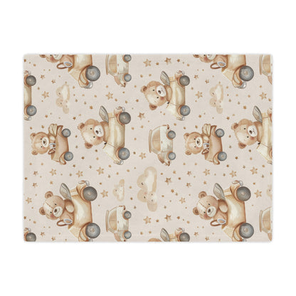 Close detail of a teddy bear driving a car on the minky blanket