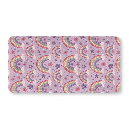 Fitted crib sheet with pastel rainbows and flowers on lilac