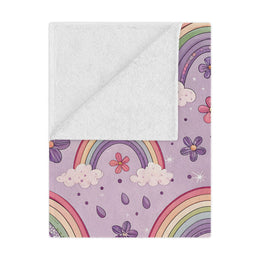 Violet Sky Rainbows minky baby blanket draped over a crib