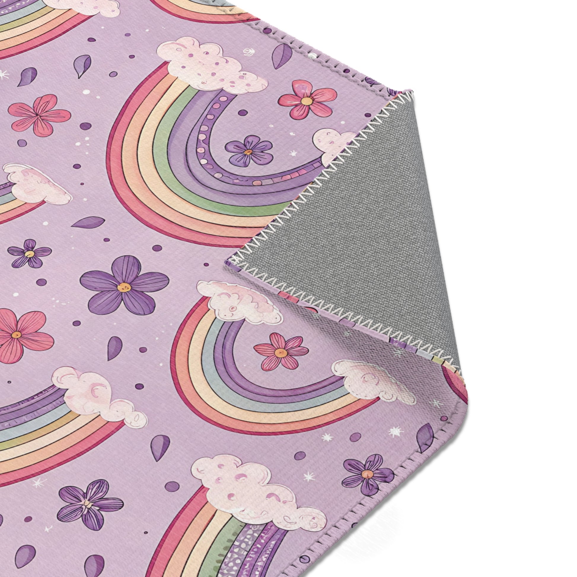 Nursery area rug printed edge to edge with pastel rainbows