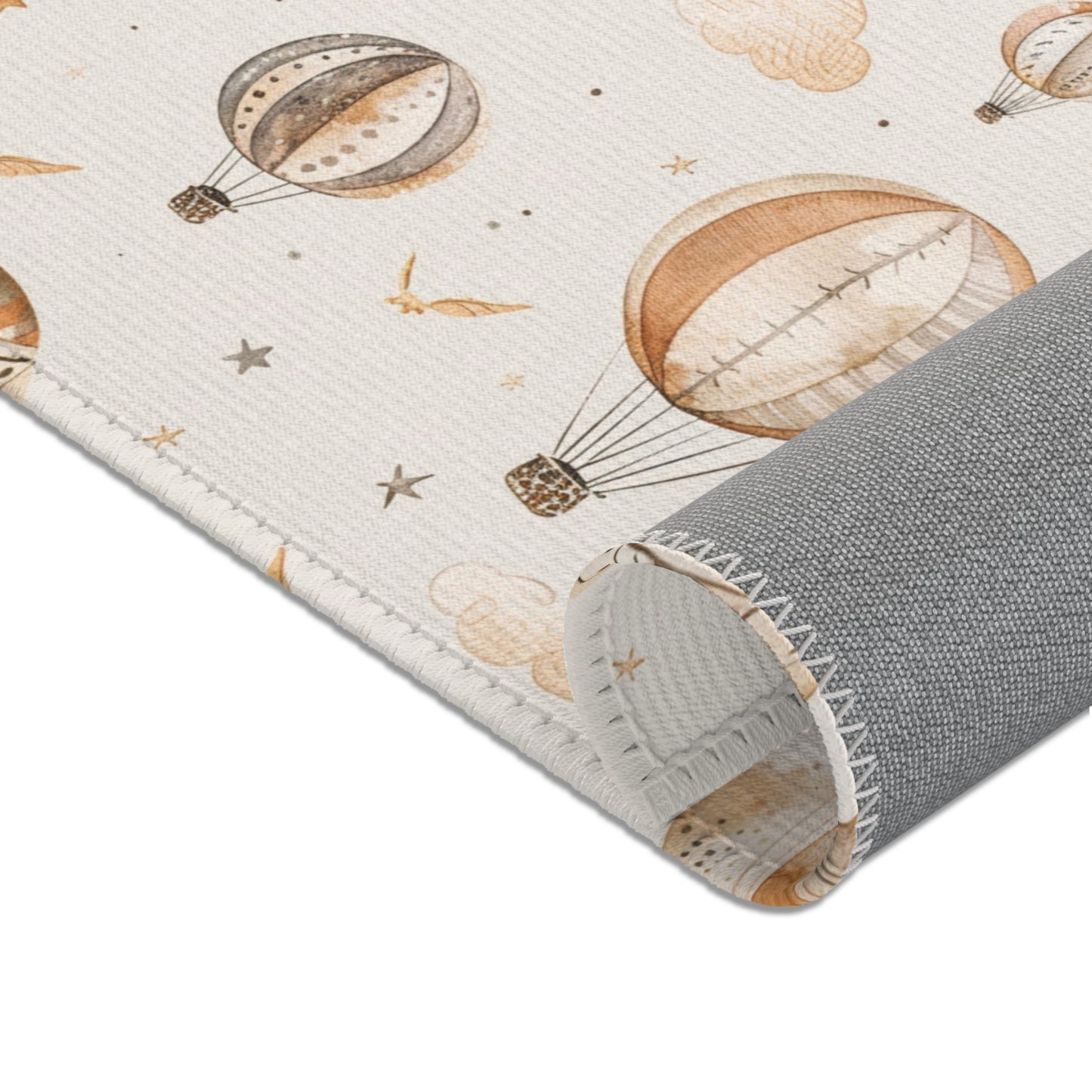 Balloons, birds and small stars printed across the area rug